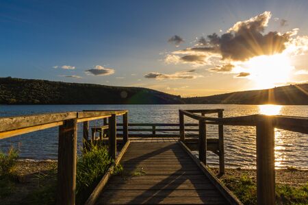Views during the beautiful sunset on the dock for fishing of the Selga de Ordas reservoir in Leon, Spainの写真素材
