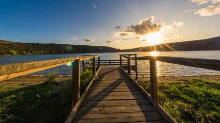 Views during the beautiful sunset on the dock for fishing of the Selga de Ordas reservoir in Leon, Spainの写真素材