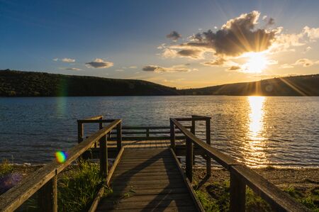 Views during the beautiful sunset on the dock for fishing of the Selga de Ordas reservoir in Leon, Spainの写真素材