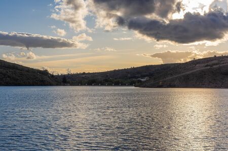 Sunset in the reservoir of Selga de Ordas reservoir in Leon, Spainの写真素材