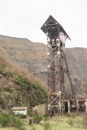 Old abandoned shaft tower of the coal mine of Pozo Ibarra in Ciñera, Leon, Spainの写真素材