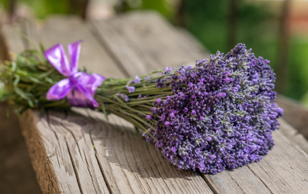 Lavender bouquet on old wooden background closeup, sunlight. Lavender flowers are used in perfumery, medicine and for making lavender oilの写真素材