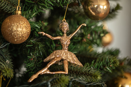 Christmas tree decoration with golden ballerina, on green backgroundの写真素材
