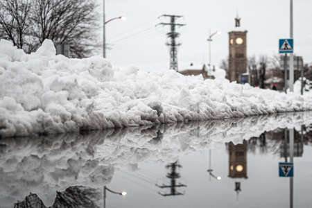 Close-up with reflection of the snow on a street in Toledo during the great snowfall of 2021の写真素材