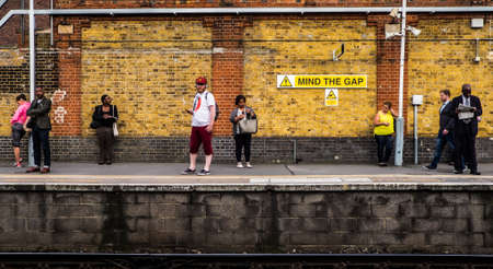 London, UK; May 9th 2018: People waiting at train station.のeditorial素材