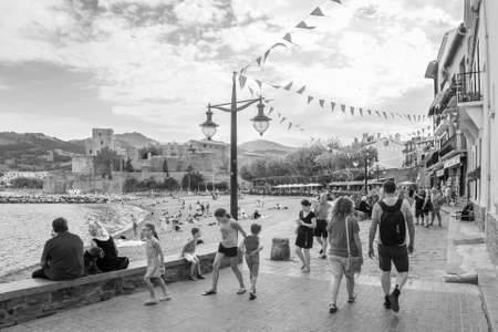 Collioure, France; August 27th 2017: People walking by the beach.のeditorial素材