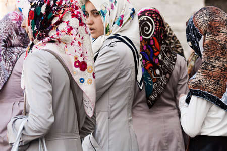 Istanbul, Turkey; May 25th 2013: Muslim women in gray coats.のeditorial素材