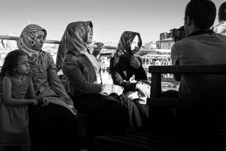 Istanbul, Turkey; May 26th 2013: Man taking photo of muslim women.のeditorial素材