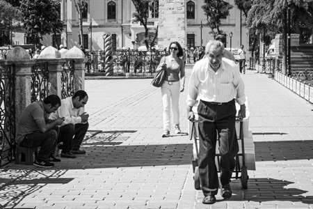 Istanbul, Turkey; May 27th 2013: Elderly man carrying a wheelbarrow down the street.のeditorial素材