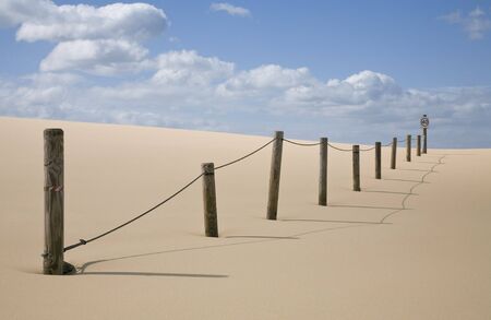 line of posts with speed limit sign in desertの写真素材