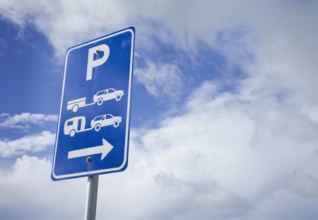 car and caravan parking sign with arrowの写真素材