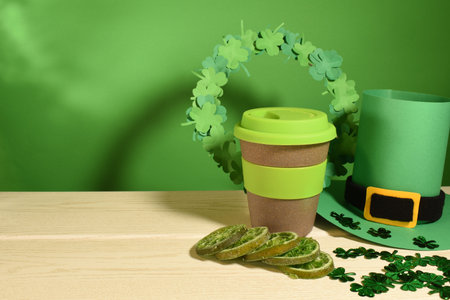 St. Patrick's Day background with paper clover wreath, lime slices, coffee and leprechaun hat