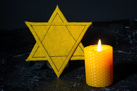 Star of David and burning candle on black background. Memorial conceptの写真素材