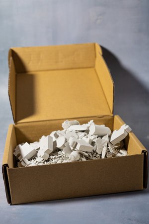 A paper box filled with plaster chips symbolizing creativity and recyclingの写真素材