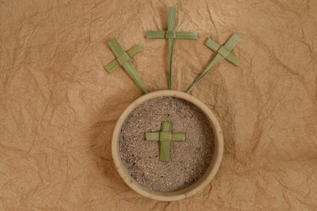 Palm crosses and ash on background. Golghota. Ash Wednesday concept.