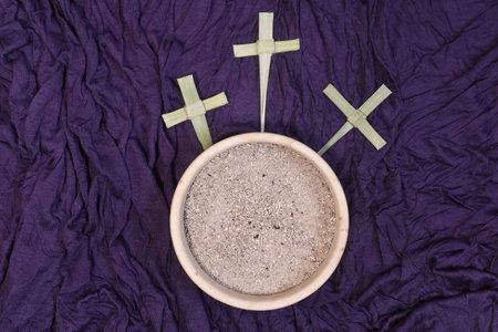 Palm crosses and ash on violet background. Golghota. Ash Wednesday concept.の写真素材