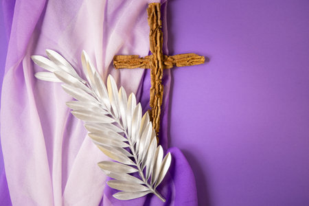 Cross and palm leaf on purple backgroundの写真素材