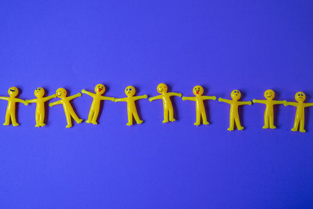 Conceptual image of a group of yellow people standing in a line.の写真素材