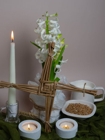 A Saint Brigidâ€™s Imbolc altar with a woven Brigidâ€™s cross, white hyacinth, lit...