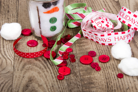 close up of christmas craft supplies laying on wood grain floorの写真素材