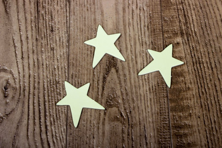star cardboard cut out shapes laying on wood grain floor