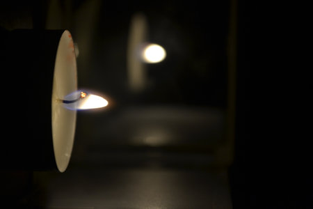 Burning candle in a dark room. Shallow depth of field.の素材