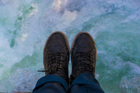 From above view of shoes with a blue river as backgroundの写真素材