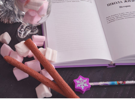 Hot winter drink with candies, Christmas or New Year decorations, dark background, rustic style, colored marshmallows.の写真素材