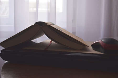 Book and black note with pen. Literature for the holidays and summer. Notes and quotes. Books on the dark table.の写真素材