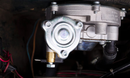Reducer of a gas installation. Auto mechanic working on a car engine in a mechanics garage. Car...