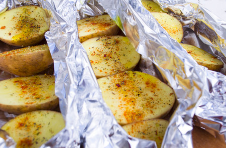 Delicious baked potatoes with rosemary on slate plate, closeupの写真素材