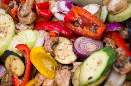 Grilled colorful vegetable: bell pepper, zucchini, eggplant on a plate over light gray slate, stone or concrete background. Top view with copy space.の写真素材