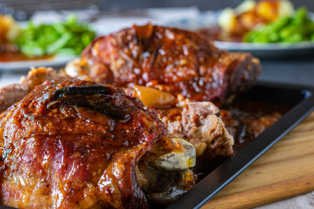 Roasted turkey shanks or legs served on a tray. Closeup view with selective focus and blurred...