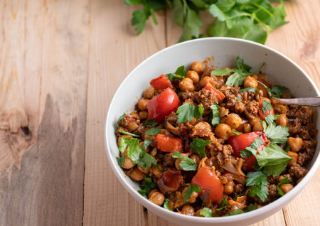 Healthy low carb dish with a ground beef stew cooked with vegetables and chick peas. Served isolated...
