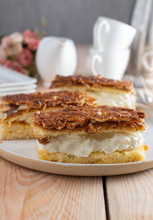 Plate with cakes. Delicious sheet cake filled with whipped cream and caramelized almond topping....