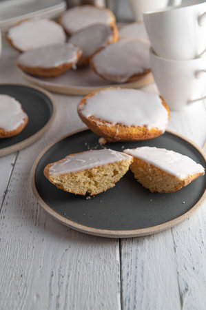 Pastry on a coffee table. Delicious homemade baked "Amerikaner" served on a white coffee table. Closeup and front view. Vertical imageの写真素材