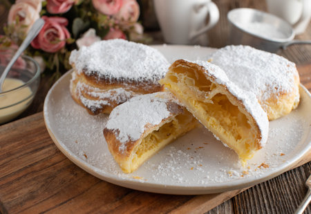 Puff pastry pockets. Delicious dessert filled with cream made with heavy sour cream, egg yolk, lemon...