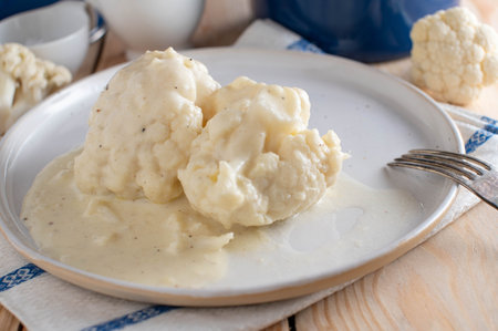 Cauliflower with bechamel sauce on a plate. Delicious dinner or lunch side dish. Fresh and homemade cooked.の写真素材