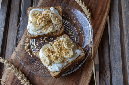 Healthy breakfast toast with quark, bananas and roasted nuts