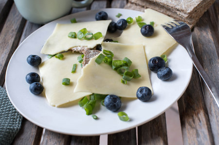 Crispbread sandwich with gouda cheese and fresh blueberries on a breakfast plate. Made with low carb, fiber breadの写真素材