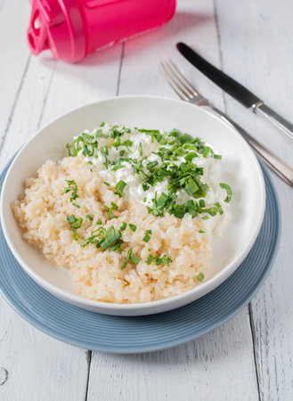 Fitness meal with brown rice, cottage cheese and chives. Healthy low fat and high protein dinner or lunchの写真素材