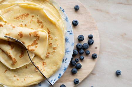 Crepes or thin pancakes stacked on a plate