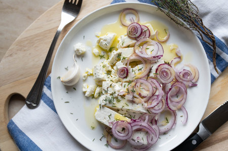 Feta cheese salad marinated with olive oil, fresh thyme, red onions. Served ready to eat on a plate...