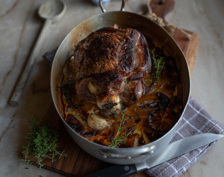 Roast turkey shank with lemon, thyme, garlic in a roasting panの写真素材