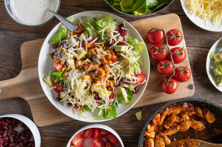Fresh vegetable salad with chicken, tomato, cucumber, lettuce, onion and cheeseの写真素材