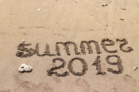 The inscription on the sand by the sea. Summer 2019 travel concept. With copy space for textの写真素材