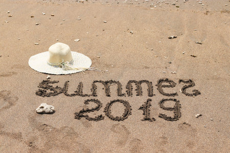 Hat on the sand by the sea, Summer 2019 travel concept, With copy space for text