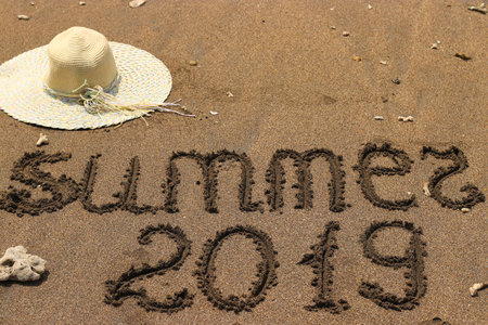 Hat on the sand by the sea, Summer 2019 travel concept, With copy space for text