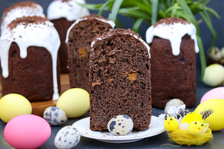 Still life with homemade chocolate Easter cakes and colorful eggs on a dark background