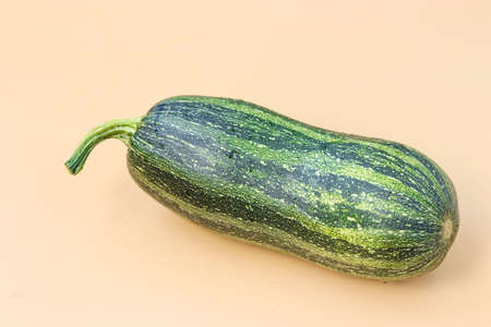 Large organic striped zucchini on light background, close-up, horizontal orientationの写真素材